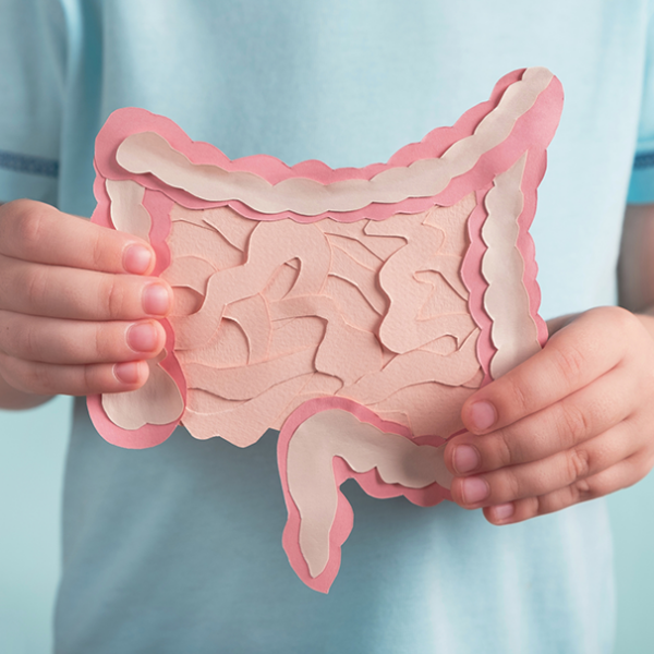 Child holding a paper image of a gut microbiome