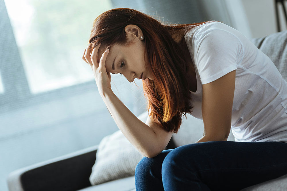 woman with treatment-resistant depression with head in hands