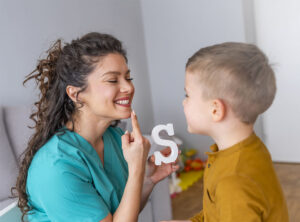 Boy with autism in speech therapy