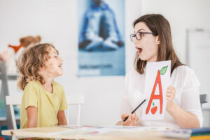 child with autism with speech therapist