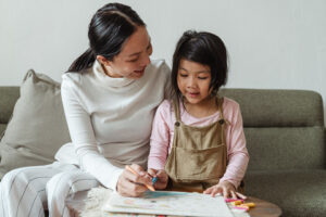 Asian mom and girl coloring