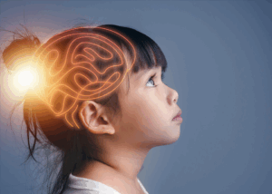 Asian girl looking up with superimposed brain illustration on her head.