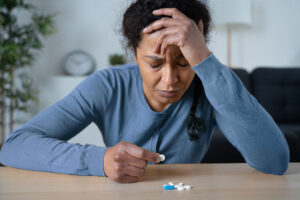 Person with treatment-resistant depression looking at a bottle of pills